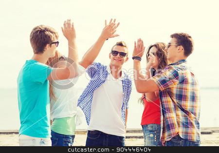 To use this stock image in your creative project, please select the size you need over to the right and click the "Add to Cart" button.
Your downloaded image will come with the Cutcaster watermark removed so don’t worry about the watermark you see on this page. group of smiling friends making high five outdoors stock photo, friendship, leisure, summer, gesture and people concept - group of smiling friends making high five outdoors by Syda Productions