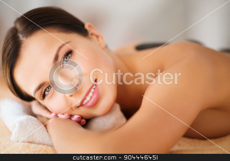 To use this stock image in your creative project, please select the size you need over to the right and click the "Add to Cart" button.
Your downloaded image will come with the Cutcaster watermark removed so don’t worry about the watermark you see on this page. beautiful woman in spa salon with hot stones stock photo, health and beauty, resort and relaxation concept - beautiful woman in spa salon with hot stones by Syda Productions