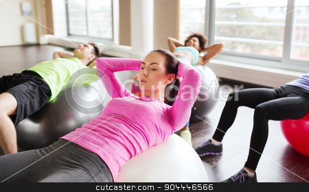 To use this stock image in your creative project, please select the size you need over to the right and click the "Add to Cart" button.
Your downloaded image will come with the Cutcaster watermark removed so don’t worry about the watermark you see on this page. happy people flexing abdominal muscles on fitball stock photo, fitness, sport, training and lifestyle concept - group of people flexing abdominal muscles on fitball in gym by Syda Productions
