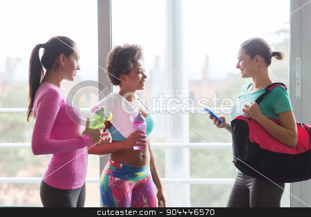 To use this stock image in your creative project, please select the size you need over to the right and click the "Add to Cart" button.
Your downloaded image will come with the Cutcaster watermark removed so don’t worry about the watermark you see on this page. happy women with bottles of water in gym stock photo, fitness, sport, training and lifestyle concept - group of happy women with bottles of water, smartphone and bag talking in gym by Syda Productions