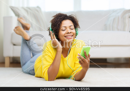 To use this stock image in your creative project, please select the size you need over to the right and click the "Add to Cart" button.
Your downloaded image will come with the Cutcaster watermark removed so don’t worry about the watermark you see on this page. happy african woman with smartphone and headphones stock photo, people, technology and leisure concept - happy african american young woman lying on floor with smartphone and headphones listening to music at home by Syda Productions