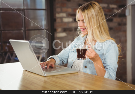 To use this stock image in your creative project, please select the size you need over to the right and click the "Add to Cart" button.
Your downloaded image will come with the Cutcaster watermark removed so don’t worry about the watermark you see on this page. Smiling woman drinking coffee and typing on laptop stock photo, Smiling woman drinking coffee and typing on laptop at coffee shop by Wavebreak Media