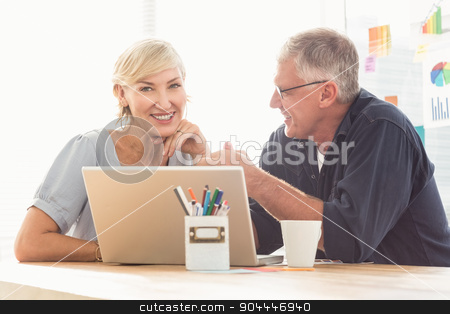To use this stock image in your creative project, please select the size you need over to the right and click the "Add to Cart" button.
Your downloaded image will come with the Cutcaster watermark removed so don’t worry about the watermark you see on this page. Smiling business team working on laptop stock photo, Portrait of smiling business team working on laptop at office by Wavebreak Media