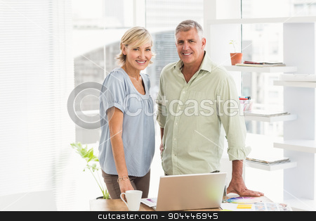 To use this stock image in your creative project, please select the size you need over to the right and click the "Add to Cart" button.
Your downloaded image will come with the Cutcaster watermark removed so don’t worry about the watermark you see on this page. Smiling business team looking at the camera stock photo, Portrait of a business team working on a laptop at office by Wavebreak Media