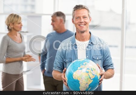 To use this stock image in your creative project, please select the size you need over to the right and click the "Add to Cart" button.
Your downloaded image will come with the Cutcaster watermark removed so don’t worry about the watermark you see on this page. Smiling businessman holding terrestrial globe stock photo, Portrait of a smiling businessman holding terrestrial globe at office by Wavebreak Media