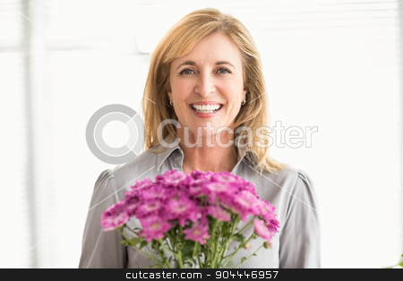 To use this stock image in your creative project, please select the size you need over to the right and click the "Add to Cart" button.
Your downloaded image will come with the Cutcaster watermark removed so don’t worry about the watermark you see on this page. Smiling casual businesswoman holding flowers stock photo, Portrait of smiling casual businesswoman holding flowers in the office by Wavebreak Media