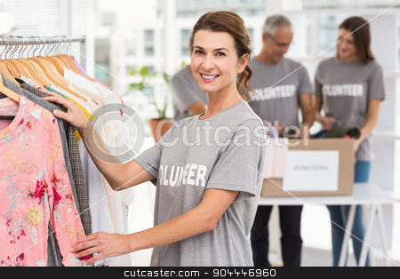 To use this stock image in your creative project, please select the size you need over to the right and click the "Add to Cart" button.
Your downloaded image will come with the Cutcaster watermark removed so don’t worry about the watermark you see on this page. Smiling female volunteer choosing clothes stock photo, Portrait of smiling female volunteer choosing clothes in the office by Wavebreak Media