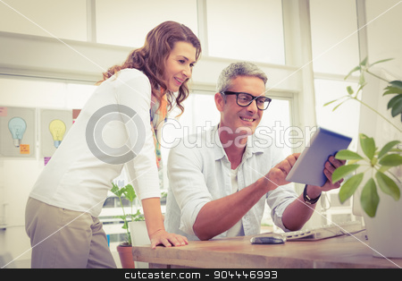 To use this stock image in your creative project, please select the size you need over to the right and click the "Add to Cart" button.
Your downloaded image will come with the Cutcaster watermark removed so don’t worry about the watermark you see on this page. Two smiling casual designers working with tablet stock photo, Two smiling casual designers working with tablet in the office by Wavebreak Media