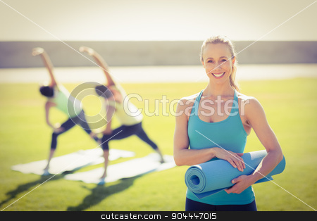 To use this stock image in your creative project, please select the size you need over to the right and click the "Add to Cart" button.
Your downloaded image will come with the Cutcaster watermark removed so don’t worry about the watermark you see on this page. Smiling sporty blonde in front of friends doing exercises stock photo, Portrait of smiling sporty blonde in front of friends doing exercises in parkland by Wavebreak Media