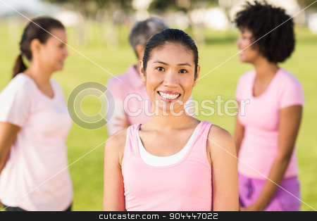 To use this stock image in your creative project, please select the size you need over to the right and click the "Add to Cart" button.
Your downloaded image will come with the Cutcaster watermark removed so don’t worry about the watermark you see on this page. Smiling woman wearing pink for breast cancer in front of friends stock photo, Portrait of smiling woman wearing pink for breast cancer in front of friends by Wavebreak Media