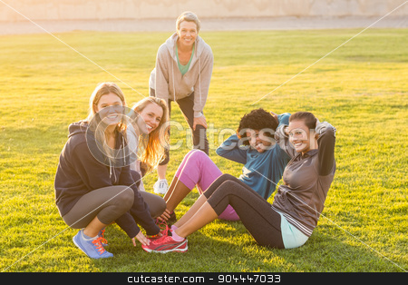 To use this stock image in your creative project, please select the size you need over to the right and click the "Add to Cart" button.
Your downloaded image will come with the Cutcaster watermark removed so don’t worry about the watermark you see on this page. Smiling sporty women doing sit ups during fitness class stock photo, Portrait of smiling sporty women doing sit ups during fitness class in parkland by Wavebreak Media