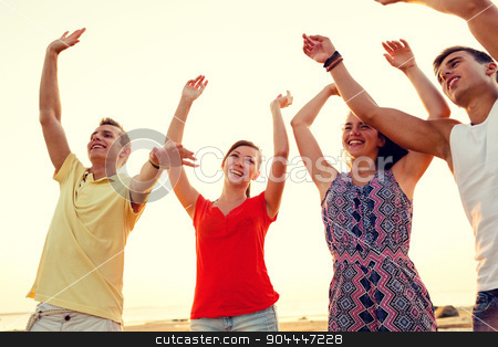 To use this stock image in your creative project, please select the size you need over to the right and click the "Add to Cart" button.
Your downloaded image will come with the Cutcaster watermark removed so don’t worry about the watermark you see on this page. smiling friends dancing on summer beach stock photo, friendship, summer vacation, holidays, party and people concept - group of smiling friends dancing on beach by Syda Productions