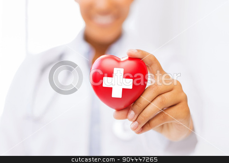 To use this stock image in your creative project, please select the size you need over to the right and click the "Add to Cart" button.
Your downloaded image will come with the Cutcaster watermark removed so don’t worry about the watermark you see on this page. female doctor holding heart with red cross symbol stock photo, healthcare and medicine concept - female african american doctor holding heart with red cross symbol by Syda Productions