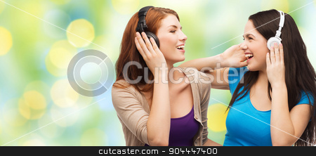 To use this stock image in your creative project, please select the size you need over to the right and click the "Add to Cart" button.
Your downloaded image will come with the Cutcaster watermark removed so don’t worry about the watermark you see on this page. two happy girls with headphones listening to music stock photo, music and technology concept - two laughing teenage girls or young women with headphones listening to music over green lights background by Syda Productions