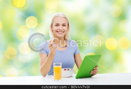 To use this stock image in your creative project, please select the size you need over to the right and click the "Add to Cart" button.
Your downloaded image will come with the Cutcaster watermark removed so don’t worry about the watermark you see on this page. smiling woman with tablet pc eating breakfast stock photo, healthy eating, dieting and people concept - smiling young woman with tablet pc computer eating breakfast over summer green holidays lights background by Syda Productions