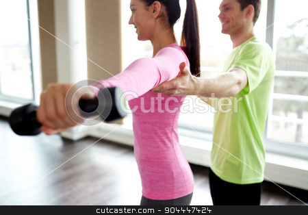 To use this stock image in your creative project, please select the size you need over to the right and click the "Add to Cart" button.
Your downloaded image will come with the Cutcaster watermark removed so don’t worry about the watermark you see on this page. smiling young woman with personal trainer in gym stock photo, fitness, sport, exercising and people concept - smiling young woman and personal trainer with dumbbells flexing muscles in gym by Syda Productions