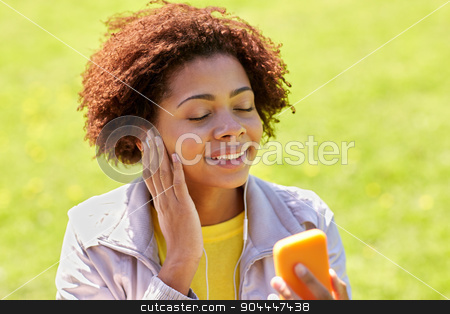 To use this stock image in your creative project, please select the size you need over to the right and click the "Add to Cart" button.
Your downloaded image will come with the Cutcaster watermark removed so don’t worry about the watermark you see on this page. happy african woman with smartphone and earphones stock photo, technology, lifestyle and people concept - happy african american young woman or teenage girl with smartphone and earphones listening to music in summer park by Syda Productions