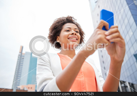 To use this stock image in your creative project, please select the size you need over to the right and click the "Add to Cart" button.
Your downloaded image will come with the Cutcaster watermark removed so don’t worry about the watermark you see on this page. happy african businesswoman with smartphone stock photo, business, technology, communication and people concept - young smiling african american businesswoman with smartphone in city by Syda Productions