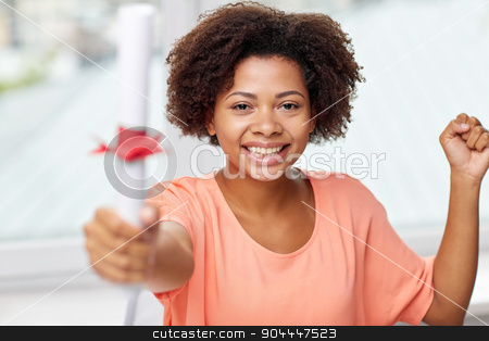 To use this stock image in your creative project, please select the size you need over to the right and click the "Add to Cart" button.
Your downloaded image will come with the Cutcaster watermark removed so don’t worry about the watermark you see on this page. happy african american woman with diploma at home stock photo, people, graduation and education concept - happy african american woman with diploma at home by Syda Productions