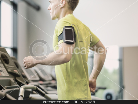 To use this stock image in your creative project, please select the size you need over to the right and click the "Add to Cart" button.
Your downloaded image will come with the Cutcaster watermark removed so don’t worry about the watermark you see on this page. man with smartphone exercising on treadmill in gym stock photo, sport, fitness, lifestyle, technology and people concept - man with smartphone and earphones exercising on treadmill in gym by Syda Productions