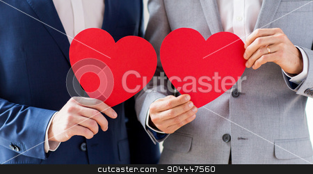 To use this stock image in your creative project, please select the size you need over to the right and click the "Add to Cart" button.
Your downloaded image will come with the Cutcaster watermark removed so don’t worry about the watermark you see on this page. close up of male gay couple holding red hearts stock photo, people, homosexuality, same-sex marriage, valentines day and love concept - close up of happy married male gay couple holding red paper heart shapes on wedding by Syda Productions