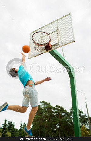 To use this stock image in your creative project, please select the size you need over to the right and click the "Add to Cart" button.
Your downloaded image will come with the Cutcaster watermark removed so don’t worry about the watermark you see on this page. young man playing basketball outdoors stock photo, sport, game and basketball concept - young man throwing ball into basket outdoors by Syda Productions
