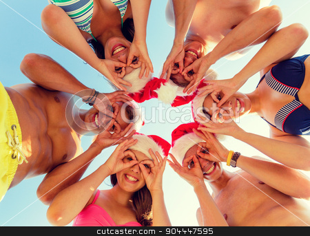 To use this stock image in your creative project, please select the size you need over to the right and click the "Add to Cart" button.
Your downloaded image will come with the Cutcaster watermark removed so don’t worry about the watermark you see on this page. smiling friends in circle on summer beach stock photo, friendship, christmas, summer vacation, holidays and people concept - group of smiling friends wearing swimwear and santa helper hats standing and having fun in circle over blue sky by Syda Productions