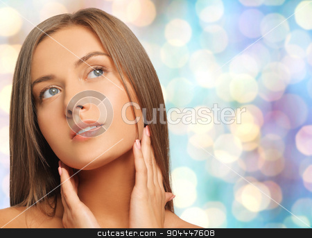 To use this stock image in your creative project, please select the size you need over to the right and click the "Add to Cart" button.
Your downloaded image will come with the Cutcaster watermark removed so don’t worry about the watermark you see on this page. beautiful young woman touching her neck stock photo, beauty, people and health concept - beautiful young woman touching her neck over blue holidays lights background by Syda Productions