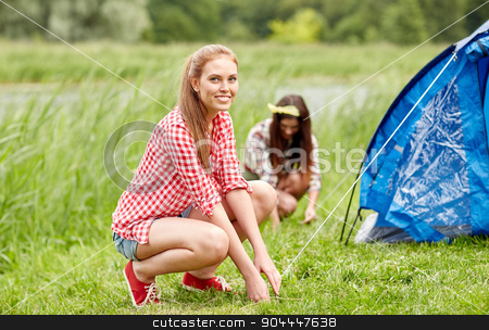 To use this stock image in your creative project, please select the size you need over to the right and click the "Add to Cart" button.
Your downloaded image will come with the Cutcaster watermark removed so don’t worry about the watermark you see on this page. smiling friends setting up tent outdoors stock photo, camping, travel, tourism, hike and people concept - smiling friends setting up tent outdoors by Syda Productions