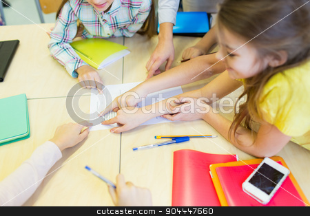 To use this stock image in your creative project, please select the size you need over to the right and click the "Add to Cart" button.
Your downloaded image will come with the Cutcaster watermark removed so don’t worry about the watermark you see on this page. group of school kids pointing fingers to test stock photo, education, elementary school, learning and people concept - close up of school kids pointing fingers to paper with test on desk at classroom by Syda Productions