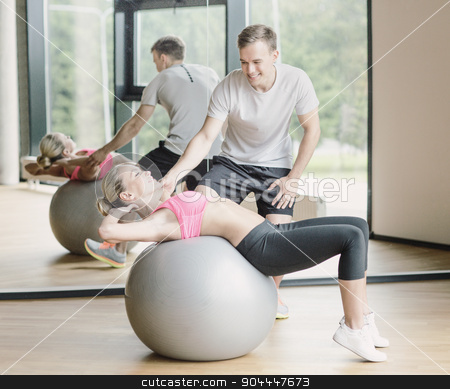 To use this stock image in your creative project, please select the size you need over to the right and click the "Add to Cart" button.
Your downloaded image will come with the Cutcaster watermark removed so don’t worry about the watermark you see on this page. smiling young woman with personal trainer in gym stock photo, fitness, sport, exercising and diet concept - smiling young woman and personal trainer in gym by Syda Productions
