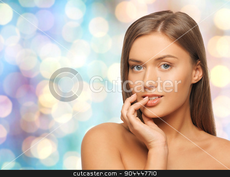 To use this stock image in your creative project, please select the size you need over to the right and click the "Add to Cart" button.
Your downloaded image will come with the Cutcaster watermark removed so don’t worry about the watermark you see on this page. beautiful young woman with bare shoulders stock photo, beauty, people and health concept - beautiful young woman with bare shoulders over blue holidays lights background by Syda Productions
