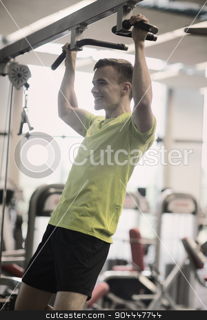 To use this stock image in your creative project, please select the size you need over to the right and click the "Add to Cart" button.
Your downloaded image will come with the Cutcaster watermark removed so don’t worry about the watermark you see on this page. smiling man exercising in gym stock photo, sport, fitness, lifestyle and people concept - smiling man doing pull-ups in gym by Syda Productions