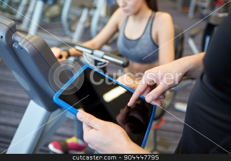 To use this stock image in your creative project, please select the size you need over to the right and click the "Add to Cart" button.
Your downloaded image will come with the Cutcaster watermark removed so don’t worry about the watermark you see on this page. close up of trainer hands with tablet pc in gym stock photo, sport, fitness, lifestyle, technology and people concept - close up of trainer hands with tablet pc computer and woman working out on exercise bike in gym by Syda Productions