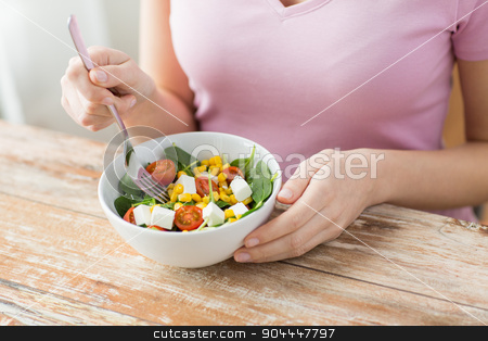 To use this stock image in your creative project, please select the size you need over to the right and click the "Add to Cart" button.
Your downloaded image will come with the Cutcaster watermark removed so don’t worry about the watermark you see on this page. close up of young woman eating salad at home stock photo, healthy eating, dieting and people concept - close up of young woman eating vegetable salad at home by Syda Productions