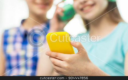 To use this stock image in your creative project, please select the size you need over to the right and click the "Add to Cart" button.
Your downloaded image will come with the Cutcaster watermark removed so don’t worry about the watermark you see on this page. close up of girls with smartphone and headphones stock photo, people, children, technology and friends concept - close up of happy little girls with smartphone and earphones listening to music by Syda Productions