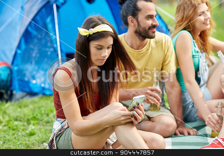 To use this stock image in your creative project, please select the size you need over to the right and click the "Add to Cart" button.
Your downloaded image will come with the Cutcaster watermark removed so don’t worry about the watermark you see on this page. happy woman with smartphone and friends at camping stock photo, travel, tourism, hike, technology and people concept - happy young woman with smartphone and friends at camping by Syda Productions