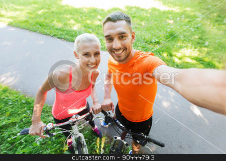 To use this stock image in your creative project, please select the size you need over to the right and click the "Add to Cart" button.
Your downloaded image will come with the Cutcaster watermark removed so don’t worry about the watermark you see on this page. couple with bicycle taking selfie outdoors stock photo, fitness, sport, people, technology and healthy lifestyle concept - happy couple with bicycle taking selfie outdoors by Syda Productions