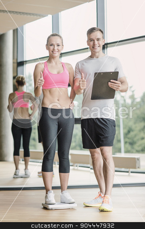 To use this stock image in your creative project, please select the size you need over to the right and click the "Add to Cart" button.
Your downloaded image will come with the Cutcaster watermark removed so don’t worry about the watermark you see on this page. smiling man and woman with scales in gym stock photo, sport, fitness, lifestyle and people concept - smiling man and woman with scales and clipboard showing thumbs up in gym by Syda Productions