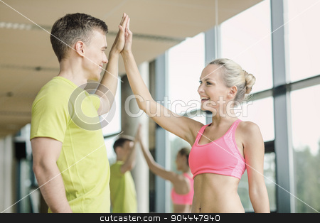 To use this stock image in your creative project, please select the size you need over to the right and click the "Add to Cart" button.
Your downloaded image will come with the Cutcaster watermark removed so don’t worry about the watermark you see on this page. smiling man and woman making high five in gym stock photo, sport, fitness, lifestyle and people concept - smiling man and woman making high five in gym by Syda Productions