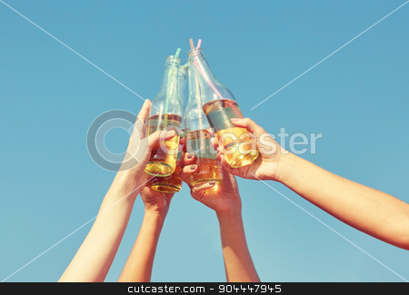 To use this stock image in your creative project, please select the size you need over to the right and click the "Add to Cart" button.
Your downloaded image will come with the Cutcaster watermark removed so don’t worry about the watermark you see on this page. close up of many hands clinking bottles stock photo, summer vacation, holidays, party and people concept - close up of many hands clinking bottles with lemonade or beer over blue sky background by Syda Productions