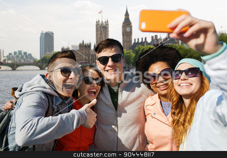 To use this stock image in your creative project, please select the size you need over to the right and click the "Add to Cart" button.
Your downloaded image will come with the Cutcaster watermark removed so don’t worry about the watermark you see on this page. smiling friends taking selfie with smartphone stock photo, tourism, travel, people, leisure and technology concept - group of smiling teenage friends taking selfie with smartphone over houses of parliament and thames river in london background by Syda Productions