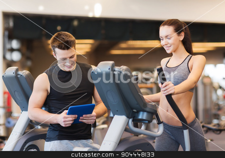 To use this stock image in your creative project, please select the size you need over to the right and click the "Add to Cart" button.
Your downloaded image will come with the Cutcaster watermark removed so don’t worry about the watermark you see on this page. woman with trainer exercising on stepper in gym stock photo, sport, fitness, lifestyle, technology and people concept - woman with trainer exercising on stepper in gym by Syda Productions