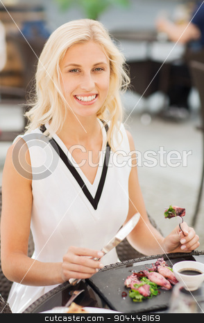 To use this stock image in your creative project, please select the size you need over to the right and click the "Add to Cart" button.
Your downloaded image will come with the Cutcaster watermark removed so don’t worry about the watermark you see on this page. happy woman eating dinner at restaurant terrace stock photo, people, holidays, food and leisure concept - happy woman with fork and knife eating squid for dinner at restaurant terrace by Syda Productions