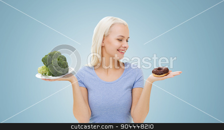 To use this stock image in your creative project, please select the size you need over to the right and click the "Add to Cart" button.
Your downloaded image will come with the Cutcaster watermark removed so don’t worry about the watermark you see on this page. smiling woman with broccoli and donut stock photo, healthy eating, junk food, diet and choice people concept - smiling woman choosing between broccoli and donut over blue background by Syda Productions