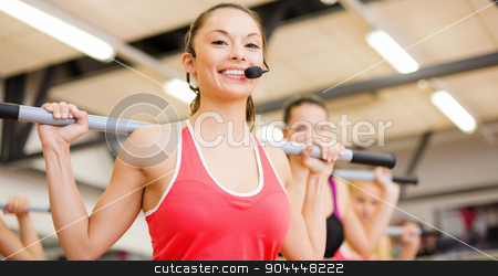 To use this stock image in your creative project, please select the size you need over to the right and click the "Add to Cart" button.
Your downloaded image will come with the Cutcaster watermark removed so don’t worry about the watermark you see on this page. group of smiling people working out with barbells stock photo, fitness, sport, training, gym and lifestyle concept - smiling trainer in front of the group of people working out with barbells in the gym by Syda Productions