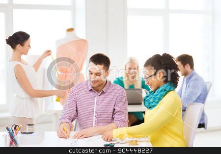 To use this stock image in your creative project, please select the size you need over to the right and click the "Add to Cart" button.
Your downloaded image will come with the Cutcaster watermark removed so don’t worry about the watermark you see on this page. smiling fashion designers working in office stock photo, startup, education, fashion and office concept - smiling designers drawing sketches and adjusting dress on mannequin in office by Syda Productions
