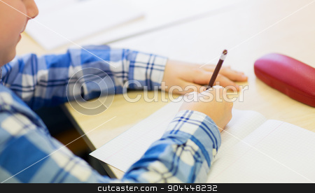 To use this stock image in your creative project, please select the size you need over to the right and click the "Add to Cart" button.
Your downloaded image will come with the Cutcaster watermark removed so don’t worry about the watermark you see on this page. close up of schoolboy writing test at school stock photo, education, elementary school, learning and people concept - close up of little schoolboy with notebook and pencil writing test at school by Syda Productions