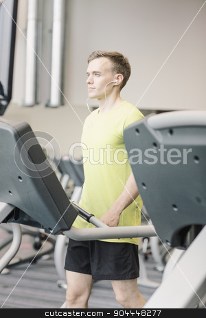 To use this stock image in your creative project, please select the size you need over to the right and click the "Add to Cart" button.
Your downloaded image will come with the Cutcaster watermark removed so don’t worry about the watermark you see on this page. man with smartphone exercising on treadmill in gym stock photo, sport, fitness, lifestyle, technology and people concept - man with earphones exercising on treadmill in gym by Syda Productions