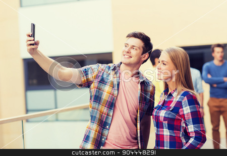 To use this stock image in your creative project, please select the size you need over to the right and click the "Add to Cart" button.
Your downloaded image will come with the Cutcaster watermark removed so don’t worry about the watermark you see on this page. group of smiling students outdoors stock photo, friendship, people, technology and education concept - group of smiling students with smartphone taking selfie outdoors by Syda Productions